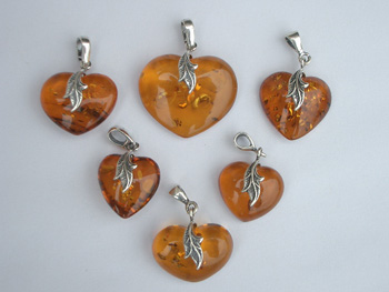 Natural clear honey amber heart pendant with sterling silver leafs. 