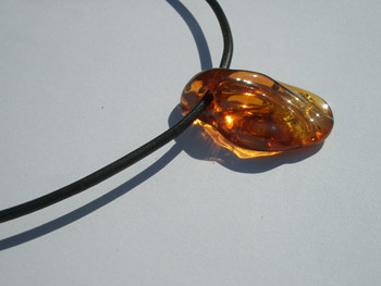 Rare cognac color amber pendant - natural free form Baltic amber