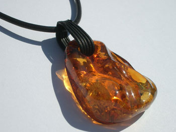 Cognac amber pendant - front drilled - on leather string
