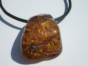 Cognac color free form pendant - amber with sparkles inside