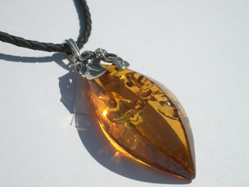 Magic natural free form faceted amber pendant - clear and sparkling on the sun. Rare exclusive amber pendant. Light clear cognac color.